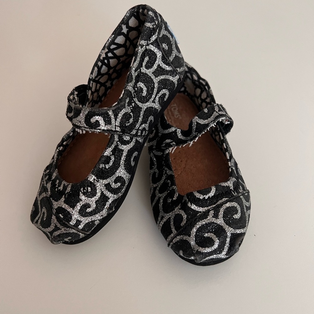 Tom’s Metallic swirl Mary Janes
